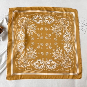 Detail of silk-satin square scarf featuring yellow paisley pattern and white polka dots