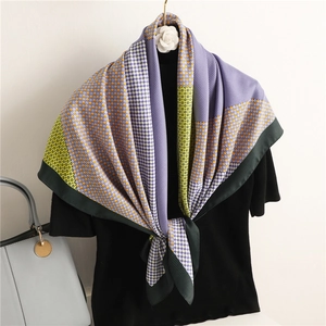 Elegant geometric silk scarf with purple dots and yellow patterns on dark green base