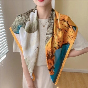 Detailed view of the artistic oil painting pattern and yellow hem on the large silk scarf