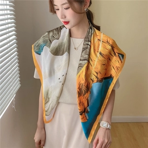 Detail of oil painting style silk scarf wrap with vibrant blue and yellow floral patterns