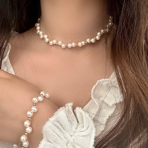 Elegant pearl necklace and bracelet jewelry set with gold beads for women