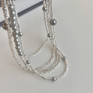 Collier multicouche orné de perles grises et de billes d'argent facettées style moderne
