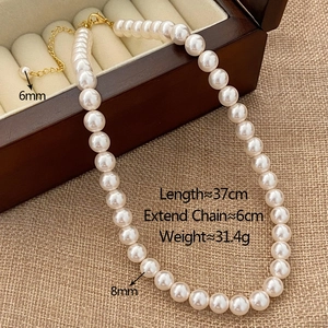 Detailed view of 8mm round pearl necklace with golden clasp and adjustable chain