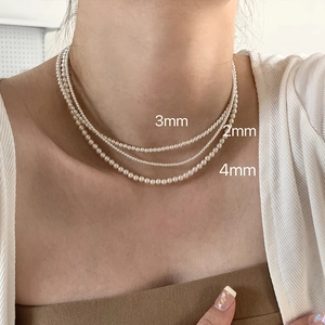 Close-up of layered pearl necklaces in 2mm, 3mm, and 4mm sizes for comparison