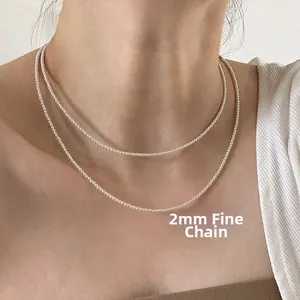 Detail of 2mm ultra-fine pearl necklace showing lustrous pearls on a model neck