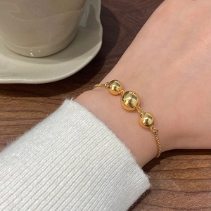 French vintage gold beaded bracelet with three polished spheres on a sleek snake chain