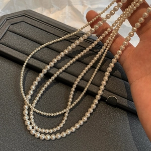 Detailed close-up showing various pearl necklace sizes from fine beads to large 10mm gems