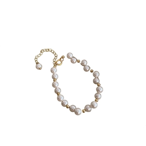Elegant white pearl bracelet with gold metal beads and adjustable extension chain