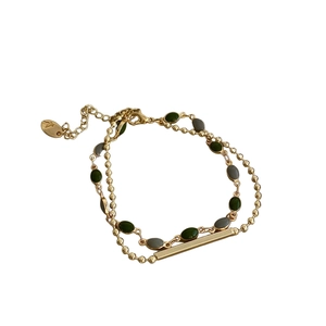 Double-layered gold bracelet featuring green oval stones and minimalist bead chain