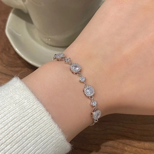 Detail of luxury halo sparkling zircon bracelet worn on wrist during tea time