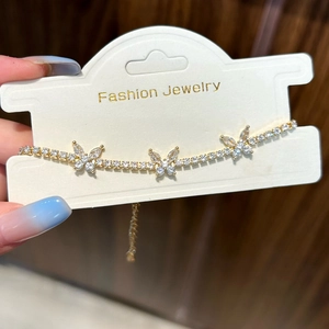 Macro detail of gold butterfly bracelet with pavé-set marquise cubic zirconia stones