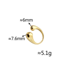 Macro shot of gold teardrop ring showing polished finish and adjustable open band