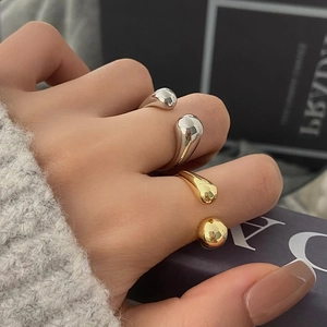 Polished minimalist water drop open rings in gold and silver finish on hand
