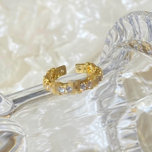 Macro shot of gold eternity band with round cubic zirconia crystals on glass rim