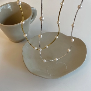 Elegant freshwater pearl necklace with twisted gold and silver chains for women
