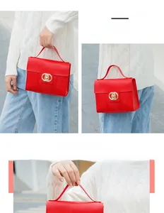 Detail of red lizard-embossed bag with gold double-ring buckle and metal chain strap
