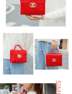 Detail of red textured crossbody bag with gold clasp and chain strap on casual outfit