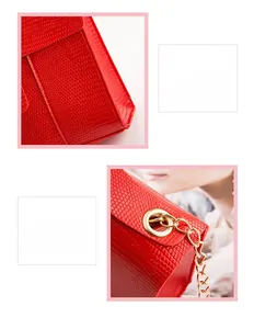 Detail of red lizard pattern leather handbag with gold metal hardware and chain strap