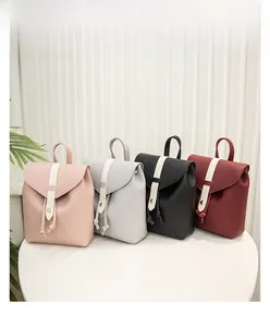 Detailed display of four mini leather backpacks in pink, gray, black and burgundy colors