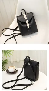 Detail of a mini black PU leather backpack with a cream contrast strap and silver buckle