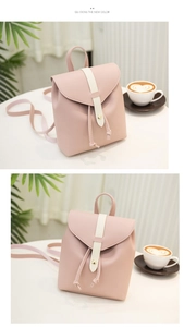 Detail view of pink mini backpack featuring contrast stitching and a gold round metal buckle