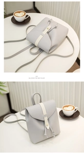 Detail of light grey drawstring backpack with contrast buckle and metal clasp