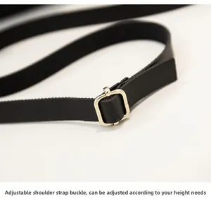 Detail of adjustable black leather strap with premium gold metal buckle for women's bag