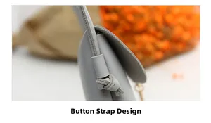 Close-up of light gray crossbody bag featuring a unique button knot strap design detail