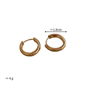 Detail of gold textured hoop earrings with 1.8cm diameter and 4g weight specs