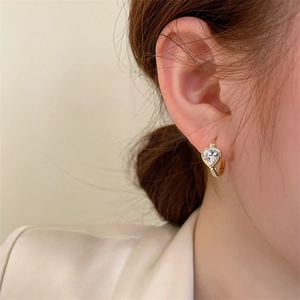 Minimalist heart-shaped zircon gold hoop earrings with rope texture on model
