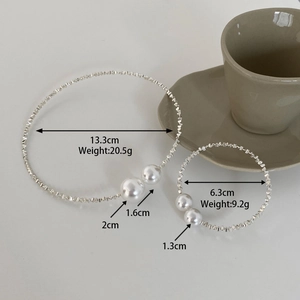 Macro detail of silver pearl necklace and bracelet set with size and weight measurements