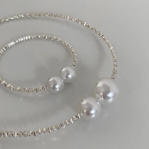 Minimalist silver metal bead necklace and bracelet set featuring two white accent pearls