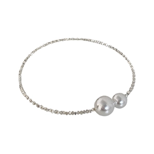 Minimalist silver textured metal bracelet with two elegant white pearls on white background