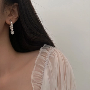 Elegant drop earrings featuring natural mother-of-pearl hearts and lustrous white pearls