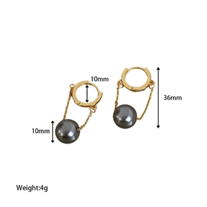 Detail showing 36mm hanging length and 10mm pearl diameter of the gold tassel earrings