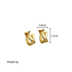 Detail shot of golden criss-cross earrings with dimensions 0.8cm width and 1.5cm height
