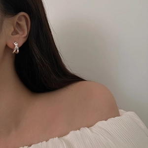 Chic silver cross-shaped metal earrings with minimalist twisted X-design for women