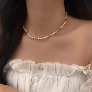 Close-up of double-layered pearl choker necklace on model neck in elegant French style