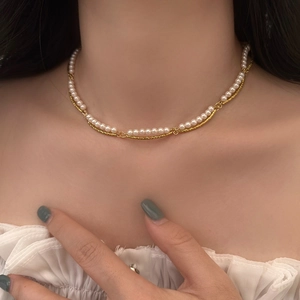 Elegant double-layered gold chain and white pearl necklace for women on neck