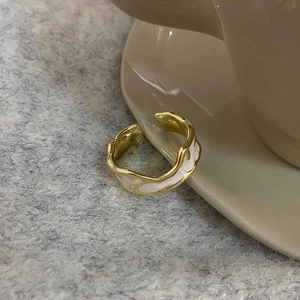 Detailed macro view of S925 sterling silver wavy ring with white enamel inlay and hallmark