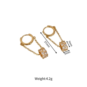 Detail view of gold tassel earrings with zircon sphere pendants and size measurements