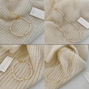 Detailed view of elegant white round pearl necklaces and bracelets with gold clasps