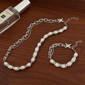 Star charm necklace and bracelet set with pearls and silver chain in a punk chic style