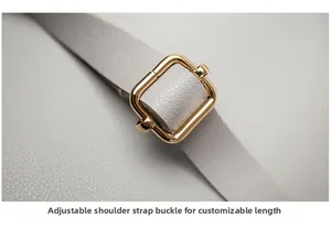 Close-up of golden adjustable buckle on grey lychee leather strap for women bag
