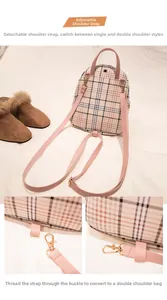 Detail view of pink and khaki plaid mini backpack with gold metal hooks and adjustable straps