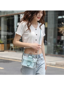 Detail of mint green transparent PVC mini bag with flip cover and decorative square buckle