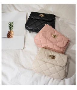 Detail view of quilted leather crossbody bags with golden oval twist-lock hardware