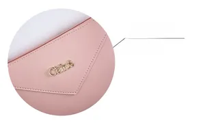 Detail of pink grainy leather texture featuring a golden metallic Chleo logo on the surface