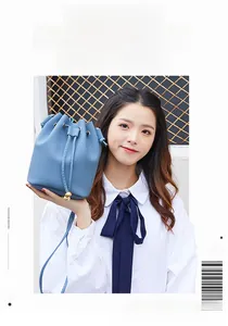 Blue litchi grain leather bucket bag detail with drawstring and metal bead toggle