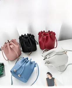 Top view of bucket bags in five colors with lychee grain leather and gold sphere accents